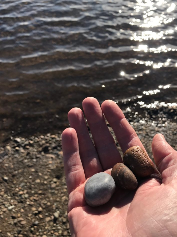 image of three stones in hand used in meditation